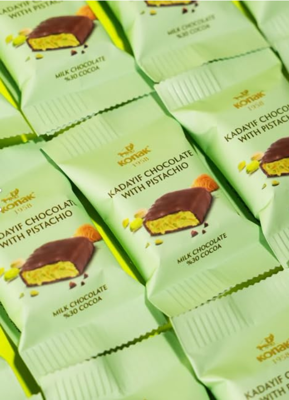 Dubai bites chocolate bars with pistachio flavor packaging on a green background, bites deal, wholesale