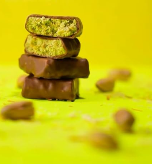 Stack of chocolate-covered treats on a yellow background, dubai bites deal